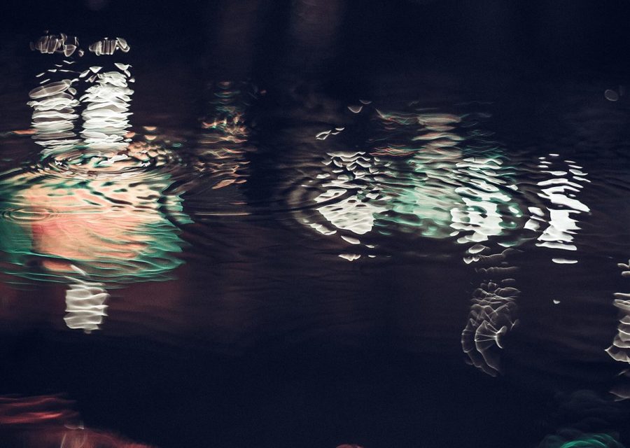 Still water holding the reflection of the building above it.